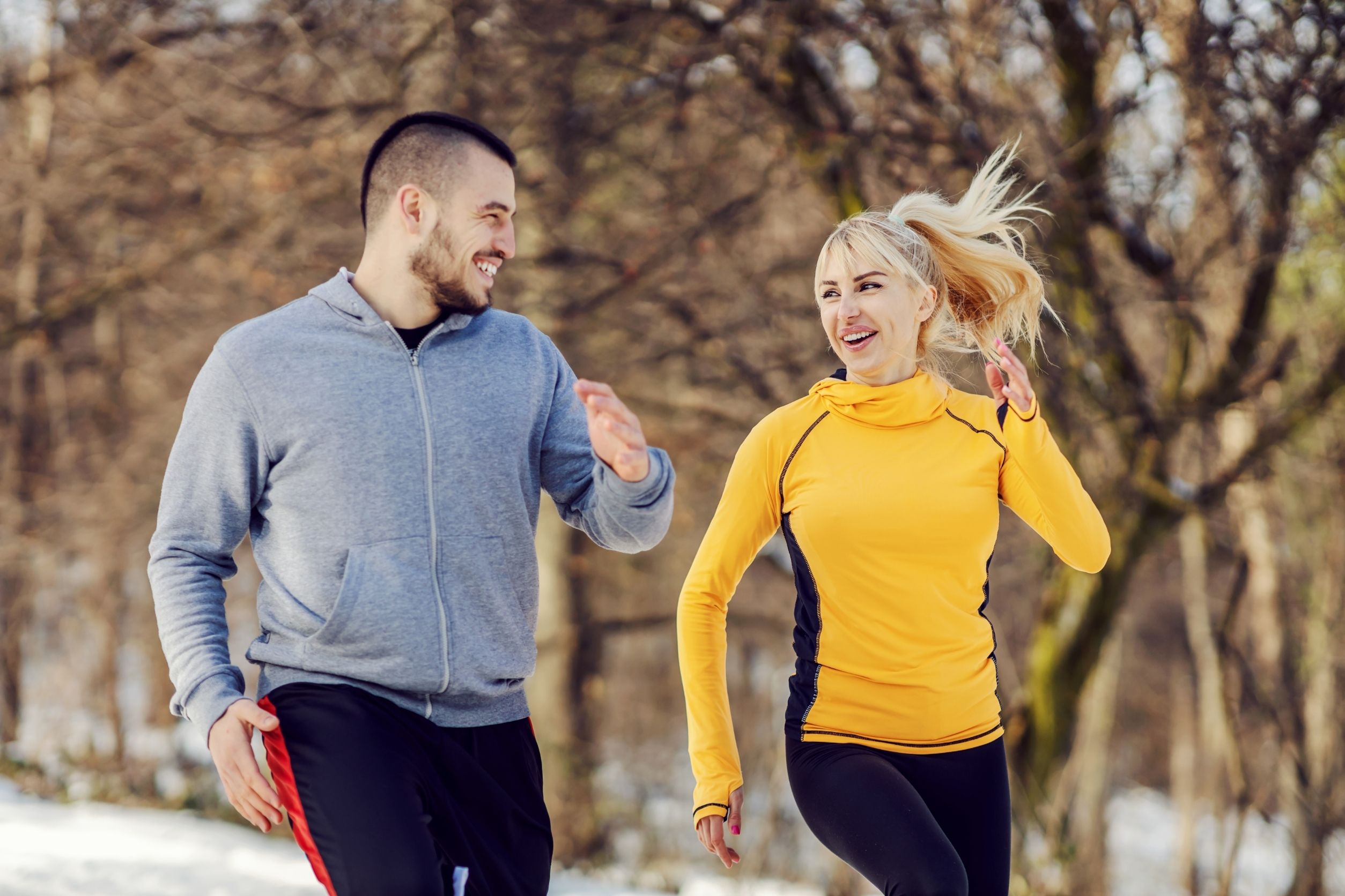 A couple is running outdoors to stay healthy.