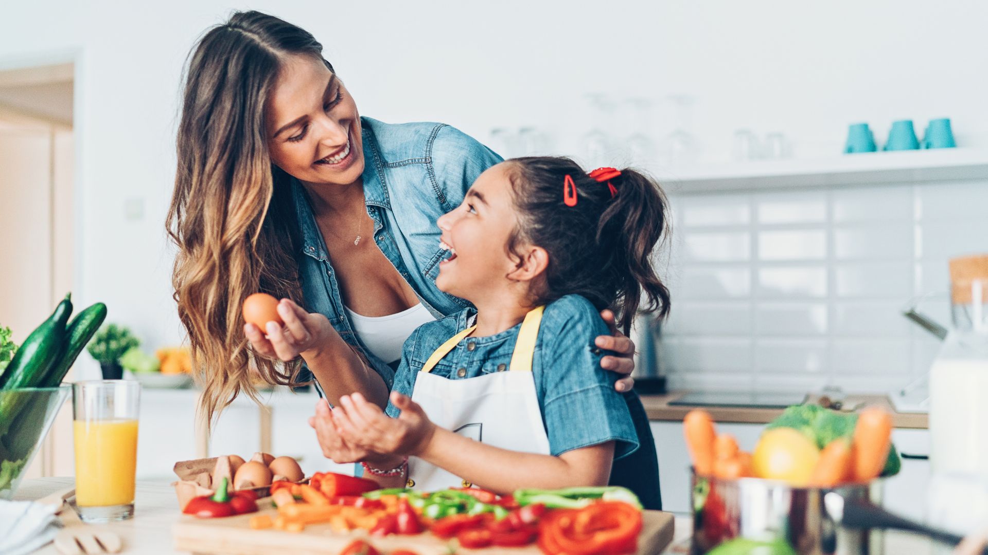 A young girl and her mom are preparing a healthy meal together. Concept to demonstrate ways of staying healthy.