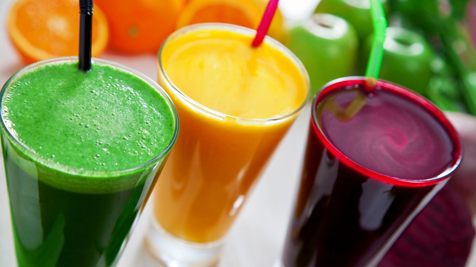 green yellow and red juice detox cleanse drinks on a table