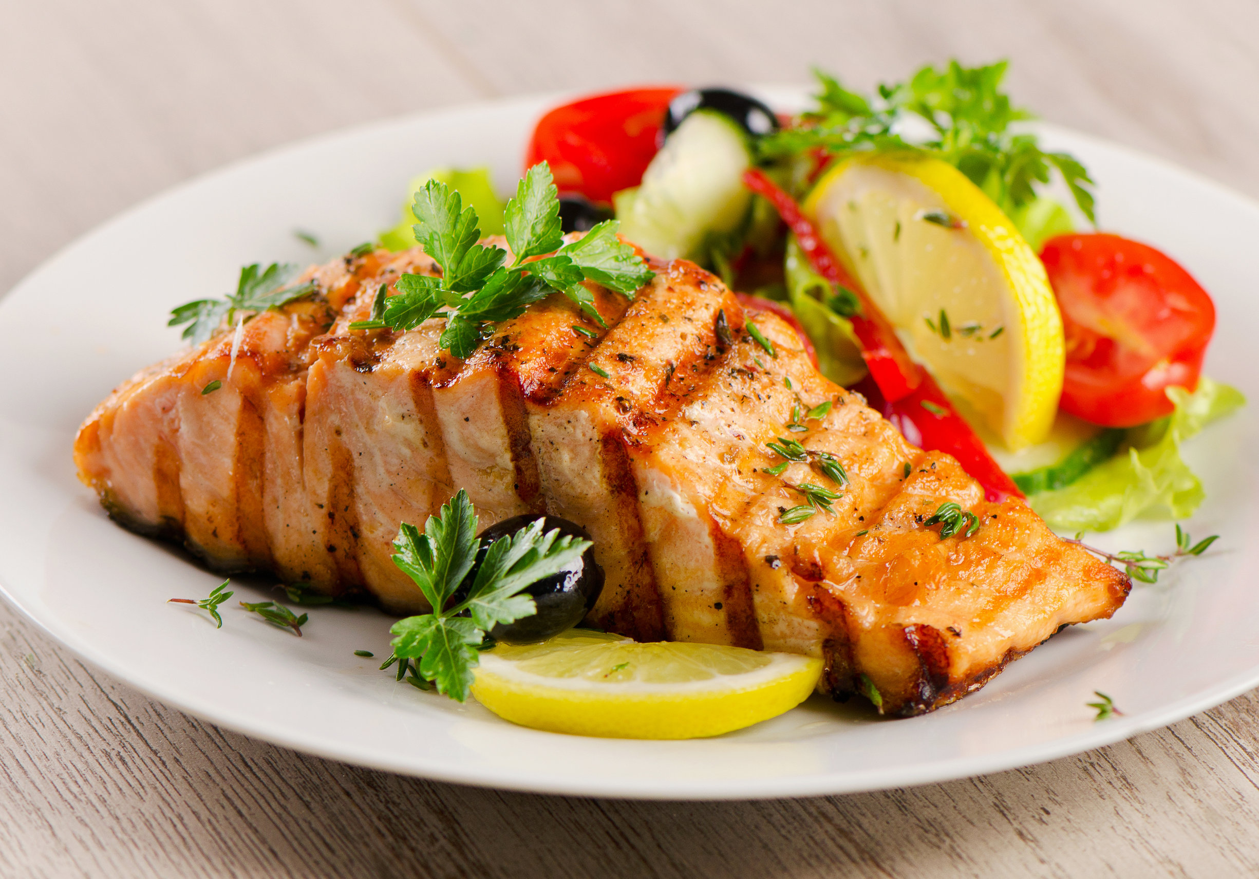 Grilled Salmon healthy food with fresh salad and lemon