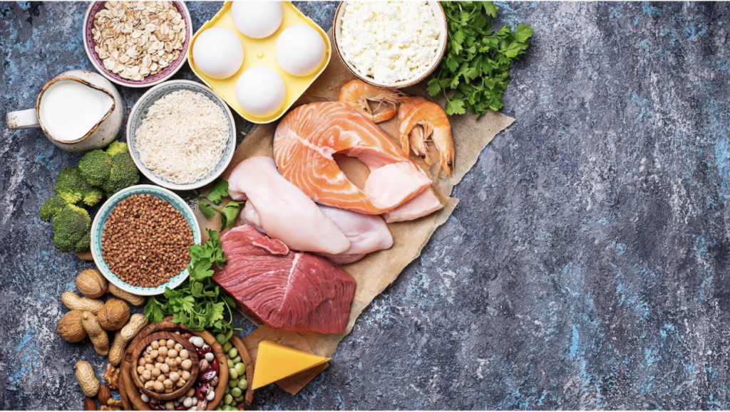 A board of healthy proteins such as fish, eggs, and grains are displayed to demonstrate healthier protein options instead of protein bars.
